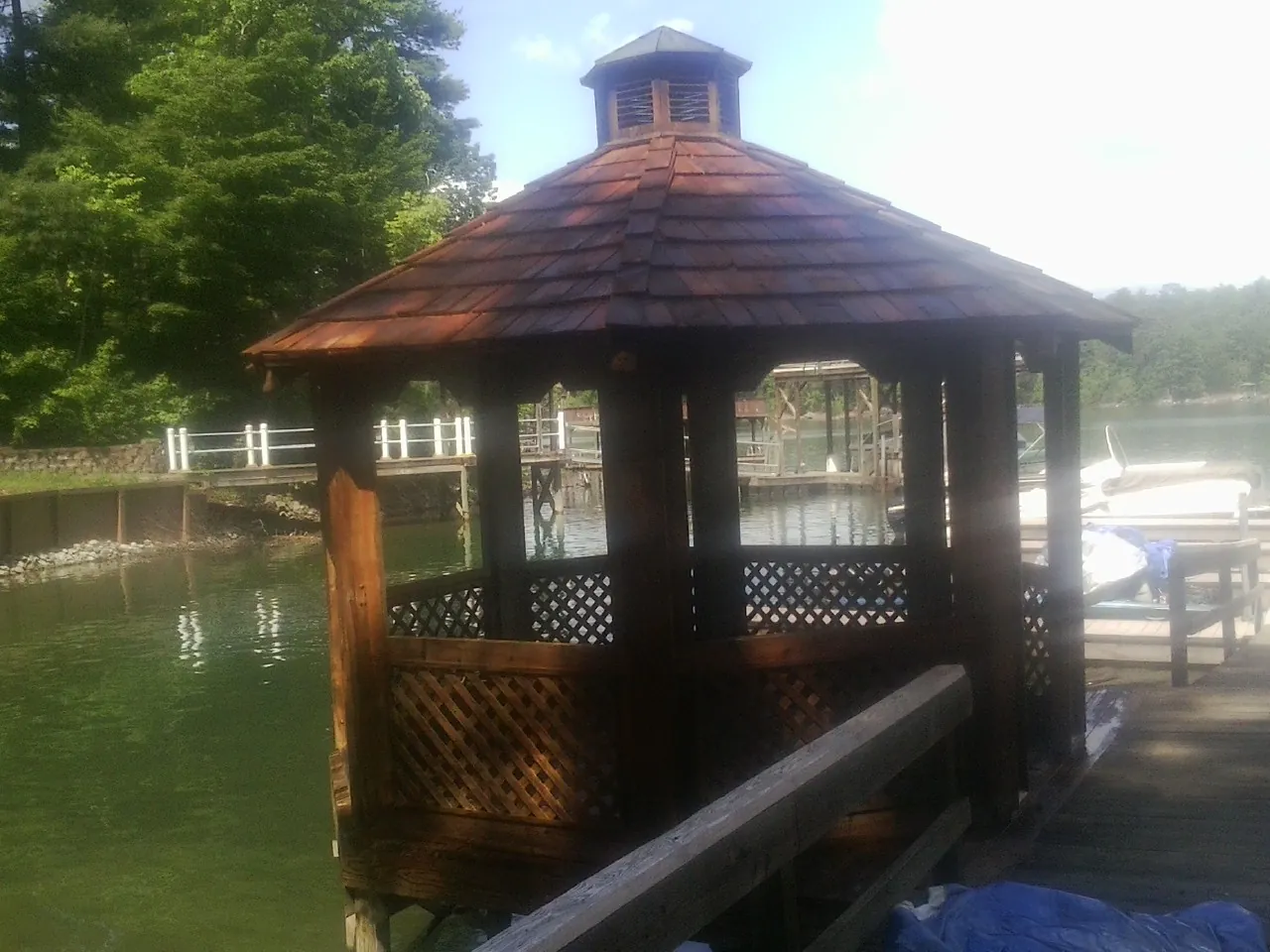 Cedar shake gazebo roof rebuilt on a lake dock in Beachwood
